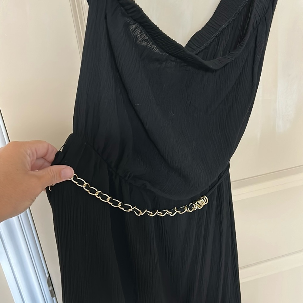 Black strapless dress with ruffles at bottom. Midi length